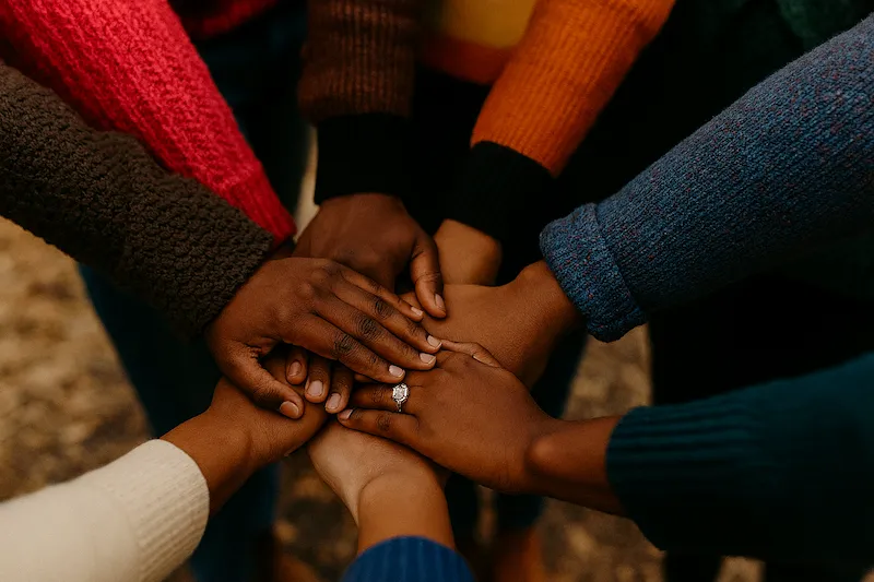 Church community joining hands in prayer